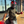 Load image into Gallery viewer, Person wearing a helmet and gloves and the 7-Strong Bruce Leroy golden dragon button down, standing on a sidewalk with a building in the background
