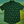 Load image into Gallery viewer, A centered view of the 7-Strong &quot;Duck O&#39; The Irish&quot; adult button down, featuring a deep green water-replicating background with various rubber ducks swimming along the waves. The shirt is featured against a green river scenic with a giant inflatable duck in the background.
