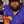 Load image into Gallery viewer, Male bartender crafting a mixed drink while wearing the 7-Strong &quot;Happy Hour&quot; button down shirt, featuring a multitude of neon colored drinks and glassware with garnishes, mixes, and the like all over a deep purple background. 

