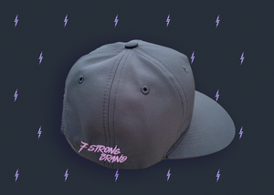 Centered close up of the side of the black 7-Strong 7-bolt logo hat featuring a 7-Strong script logo in lavender and solid back. The hat is featured a slate background with lavender 7-bolts patterned throughout.