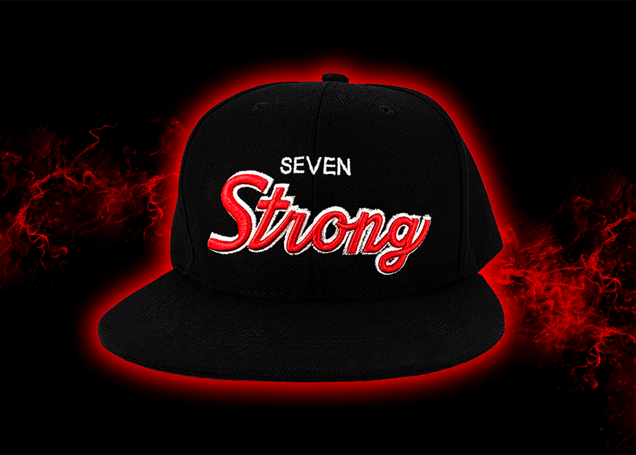 Full centered look at the Black 7-Strong Sideline Script hat, with white embroidered SEVEN and red puff scripted STRONG across the front.  Hat is on the back of a red and black fusion background. 