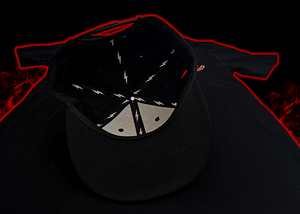 Centered underside look at the Black 7-Strong Sideline Script hat, with white 7-Bolts on the inside lining and black underbrim.  Hat is on the back of a red and black fusion background. 