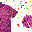 Load image into Gallery viewer, a 3/4 view of the 7-Strong adult &quot;Strongfetti&quot; button down, a bold pink shirt featuring black, yellow, lime green, and navy blue scratches that appear like confetti falling from the sky. The shirt is featured on a white background with colorful falling confetti. The bottom right of the photo features a close up circle detailing the shirt&#39;s design. 
