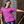 Load image into Gallery viewer, A shot of a female adult model wearing the 7-Strong adult &quot;Strongfetti&quot; button down, a bold pink shirt featuring black, yellow, lime green, and navy blue scratches that appear like confetti falling from the sky. The model is standing on stairs, leaning against a brick wall looking into camera. 
