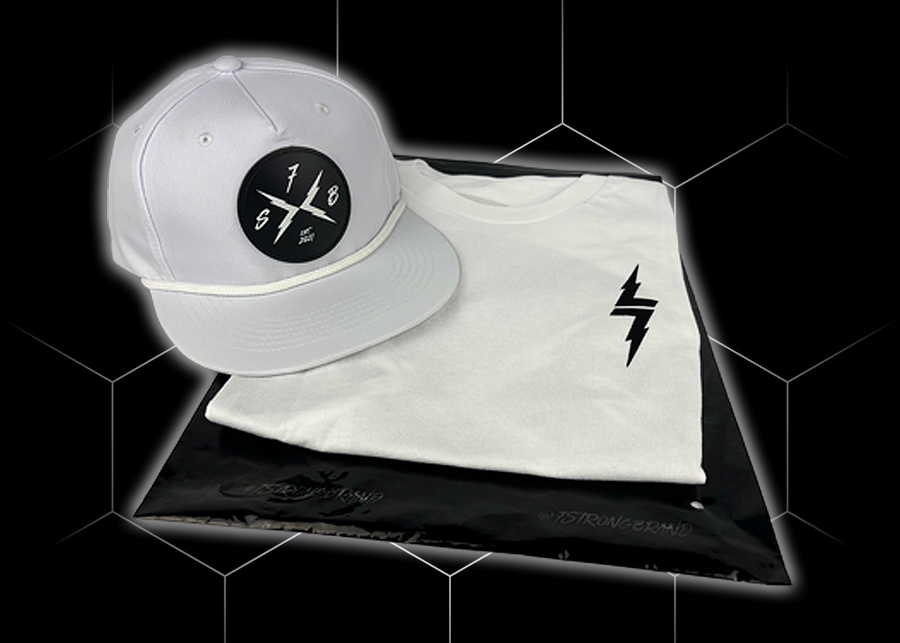 Folded and centered close up of the 7-Strong white Branded tee, featuring a 7-bolt logo left justified in black. It is paired with the white "Branded" performance hat with raised x-badge patch. Shirt is featured against a black geometric background.