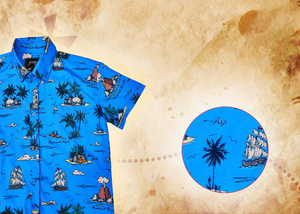 A 3/4 view of the 7-Strong "7-Seas" shirt, a bright blue colored shirt with various nautical depictions such as islands, ships, mermaids, etc - drawn in a treasure map like fashion. The shirt is displayed against a weathered treasure map and compass background. The bottom right features a detail circle with a close up of one of the shirt's drawings. 