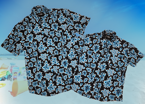 Overlapping view of the 7-Strong youth and adult Electric Palms shirts, a collection of electric blue palm fronds featured against a black shirt. Shirt is displayed against a scenic beach background.