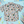 Load image into Gallery viewer, Full centered view of 7-Strong Class act button-down featuring various classroom items such as pencils, rulers, globes, notebooks, apples, protractors, etc against a white graph paper background. Shirt is against a background of school supplies. 
