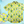Load image into Gallery viewer, Full view of the 7-Strong &quot;Late Bloomer&quot; adult button down - a yellow background shirt with white and blue flowers patterned all over it. Shirt is against a blue tropical sky with palm trees in the distance. Bottom left of photo has a detail circle which showcases the flowers on the shirt. 
