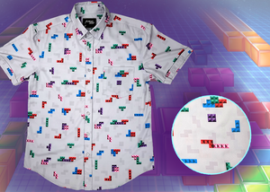 Full view of the 7-Strong Block Party adult button down, featuring various colored blocks of different arrangements inspired by a classic video game, cascading down the shirt against a grayish background featuring shadows of the same shapes. The shirt is presented on a background of similar design.In the bottom right is a detail circle with a close up of the design. 