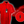 Load image into Gallery viewer, Full view of the 7-Strong Red 7-Bolt short sleeve shirt, featuring black 7-bolts with a white drop shadow interspersed on a red background. The shirt is featured on a red lightning storm backdrop. The bottom left features a detail circle showing the 7-bolt design up close. 
