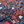 Load image into Gallery viewer, Close up of the middle button portion of the 7-Strong &quot;Aye Poppy&quot; button down which features red poppies with white sprigs against a deep navy blue background. 

