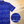 Load image into Gallery viewer, A 3/4 representation of 7-Strong&#39;s 1776 button down shirt against a Declaration of Independence background. Shirt is royal blue with stripes of various Americana icons, including the original 13 colonies and revolutionary war items. On the right of the picture, there is a close-up circle giving detail to the various icons on the shirt. 

