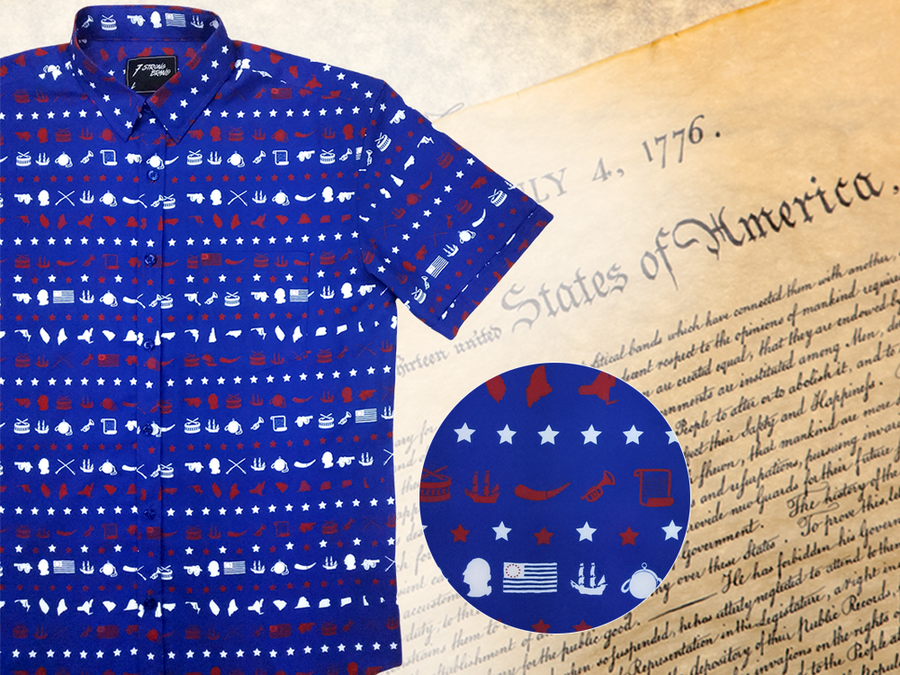A 3/4 representation of 7-Strong's 1776 button down shirt against a Declaration of Independence background. Shirt is royal blue with stripes of various Americana icons, including the original 13 colonies and revolutionary war items. On the right of the picture, there is a close-up circle giving detail to the various icons on the shirt. 