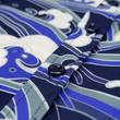 Load image into Gallery viewer, Middle button view of the 7-Strong &quot;Let &#39;Er Riptipe&quot; Adult button down shirt, featuring an array of indigo and purple waves with whitecaps all over. The shirt is featured against a purple tinted background of a wave cresting.
