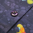 Load image into Gallery viewer, Close up shot of the button midsection of the 7-Strong Mine Train button down depicting various colored gemstones shining in a mine shaft rock quarry of deep purple color. 
