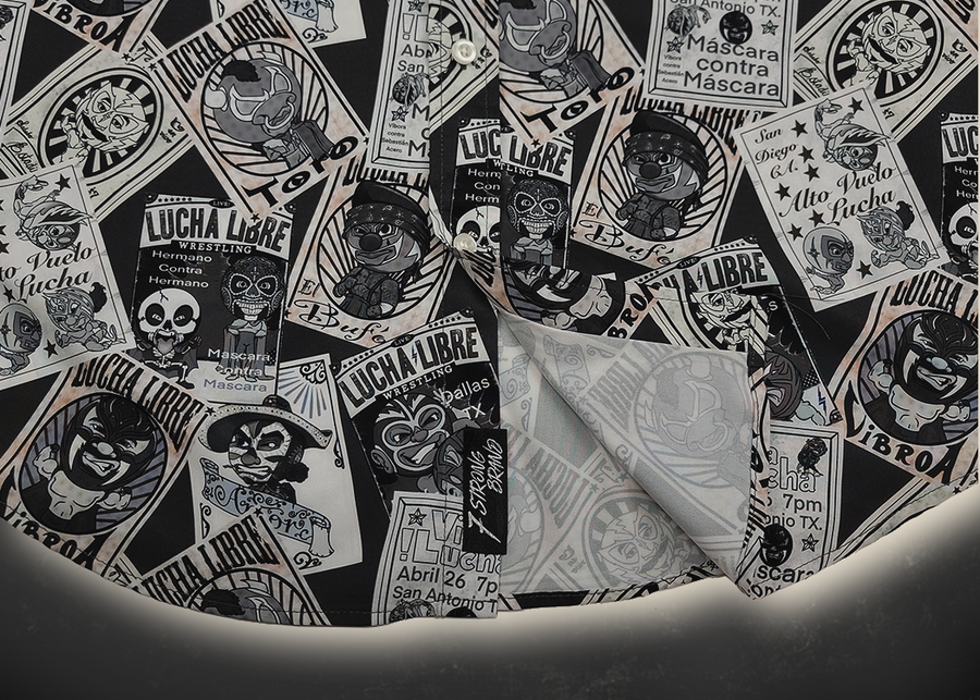 Bottom sweep tag view of the adult 7-Strong "Cinco de Mayhem" button down shirt. Shirt features black and white posters featuring various created luchadors advertised for matches, all overlapping each other over a black shirt. Shirt is displayed on a black gradient background with some of the characters ghosted in the back.