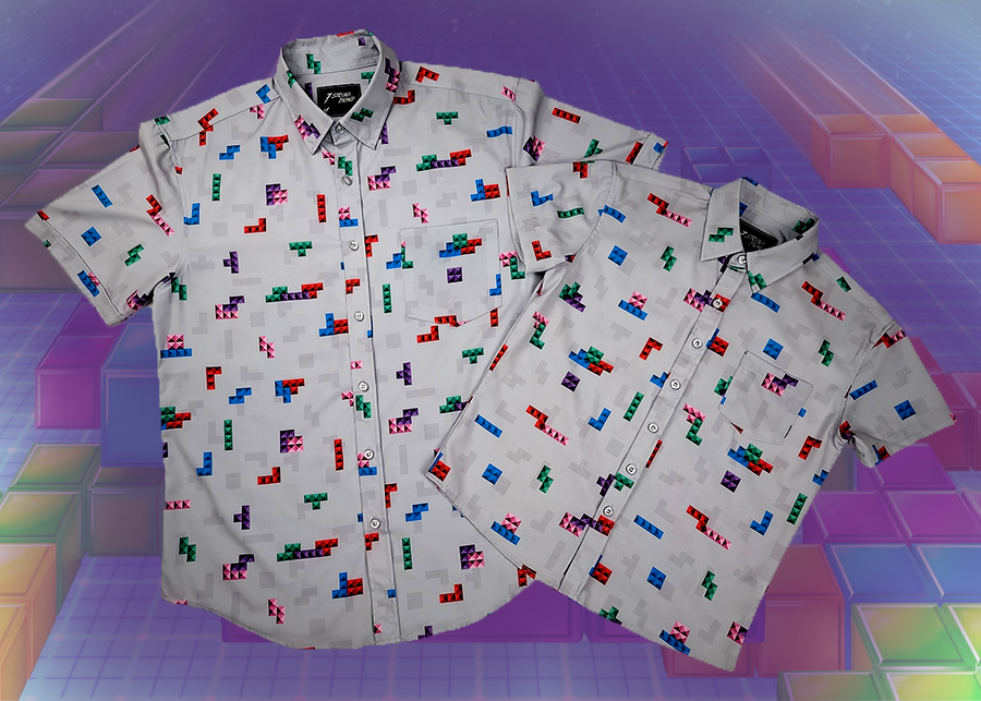 Full view of the 7-Strong Block Party adult and youth button downs overlapped on each other, featuring various colored blocks of different arrangements inspired by a classic video game, cascading down the shirt against a grayish background featuring shadows of the same shapes. The shirts are presented on a background of similar design.