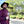 Load image into Gallery viewer, Medium close up of a model smiling towards camera wearing the 7-Strong &quot;Pour Decisions&quot; button down, layered with a maroon bomber jacket and accentuated with a wide brim black fedora - holding a glass of wine in hand at a vineyard. 
