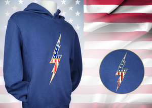 Full view of the navy blue Freedom Bolt hoodie, featured on a mannequin and showcasing a gold outlined 7-bolt with white stars on blue on top and red and white stripes on the bottom. The hoodie is featured on an American flag background. There is a detail circle in the bottom right circle featuring the 7-Bolt on the hoodie. 