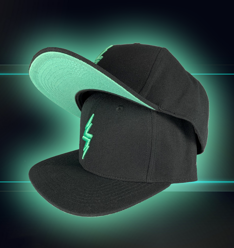 Black snapback hat on a futuristic background, hat features the mint version of the 7-Strong bolt logo. One hat is stacked on the other to illustrate the mint colors brim underneath. 