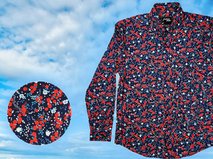 3/4 full view of the 7-Strong long sleeve "Aye Poppy" button down, featuring an array of red poppys with white sprigs on a deep navy blue shirt. The shirt is displayed against a partly cloudy sky. The bottom left has a detail circle featuring a close up of the design. 