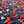 Load image into Gallery viewer, Close up of the middle button region of the &quot;Aye Poppy&quot; long sleeve button up, showcasing the red poppies and white sprigs against the deep navy blue background. 

