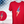 Load image into Gallery viewer, Full view of the red Freedom Bolt unisex tee, featuring a large center placed 7-bolt, outlined in gold, with white stars on blue on top and red and white stripes on the bottom. The shirt is featured on a mannequin against a U.S. flag background. In the bottom left corner, there is a detail circle featuring an up close view of the Freedom Bolt.
