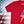 Load image into Gallery viewer, 3/4 view of the red Freedom Bolt unisex tee, featuring a large center placed 7-bolt, outlined in gold, with white stars on blue on top and red and white stripes on the bottom. The shirt is featured on a  U.S. flag background. 
