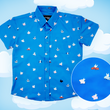 Load image into Gallery viewer, Full shot of the 7-Strong &quot;When Pigs Fly&quot; shirt, showcasing various pigs and meats flying against a blue, muted cloud background. Shirt is displayed against a background of cartoon clouds. Bottom right features a circle which details the flying pigs featured on the shirt. 
