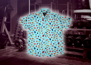 Full view of the 7-Strong "Cheat Day" youth button down featuring various snacks, treats, and fast food features on a light blue shirt. The shirt is displayed against a background of a gym weight rack