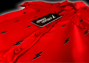 3/4 diagonal view of the 7-Strong Red 7-Bolt youth short sleeve shirt, featuring black 7-bolts with a white drop shadow interspersed on a red background. The shirt is featured on a red lightning storm backdrop.