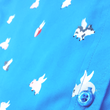 Load image into Gallery viewer, Close Up shot of the midsection area of the 7-Strong &quot;When Pigs Fly&quot; shirt, showcasing various pigs and meats flying against a blue, muted cloud background. Shirt is displayed against a background of cartoon clouds.
