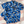 Load image into Gallery viewer, Full view close up of the 7-Strong &quot;Service Stars&quot; adult and youth button-ups overlapping each other, featuring blue and creme colored camouflage with white weathered stars throughout. The shirt is featured against a waving U.S. Flag faded into the background. Bottom right is the 22 Flag Co logo.
