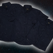 Load image into Gallery viewer, Full view of the long-sleeve, and short-sleeve adult and youth Stargazer button down shirts overlapping one another. A deep navy blue shirt with constellation star patterns throughout. The shirt is displayed against a night sky full of stars.
