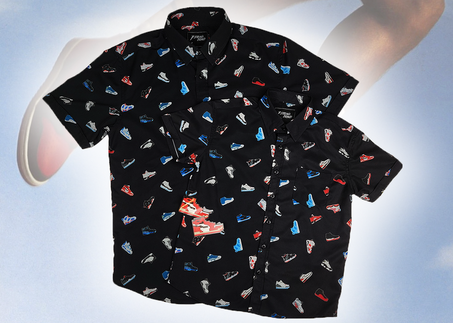 Full centered view of the youth and adult short sleeve versions of "Got 'Em!," overlapping one another. The button down features various athletic fashion sneakers in an 80bit format arranged all over a black shirt. The shirt is featured against a background of a basketball player jumping in air, noticeable sneakers being worn. 